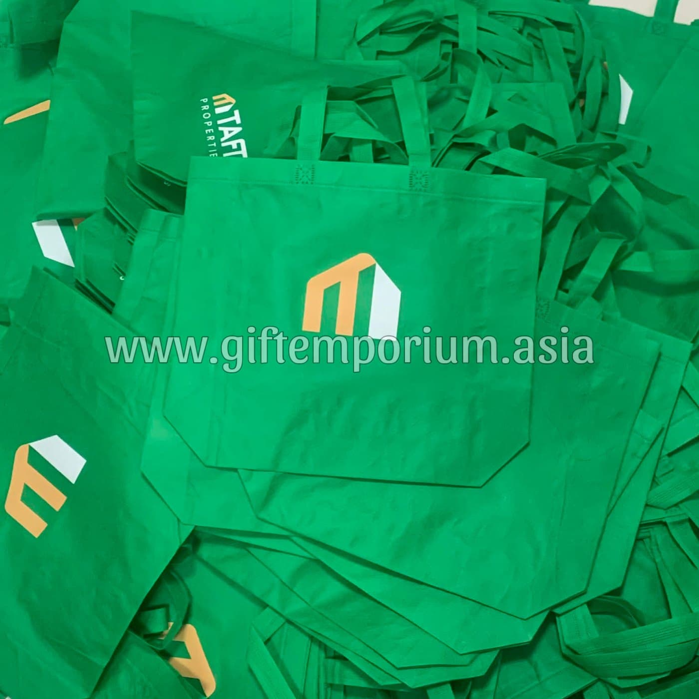 Custom-branded green tote bags for TAFT Properties