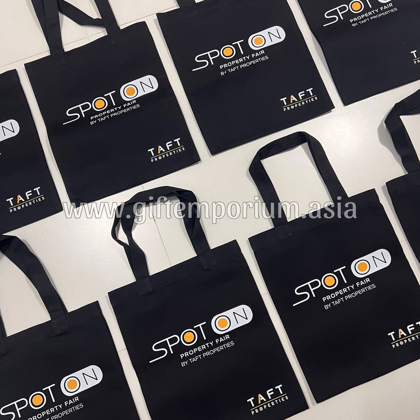 Black branded tote bags for a TAFT Properties property fair